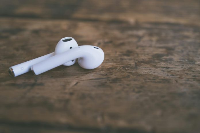 Closeup of White Wireless Headphones on a Wooden Table